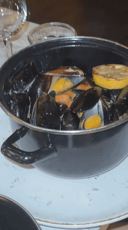 Copenhagen diners document upscale restaurant meal with champagne, mussels