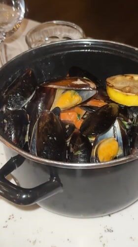 Copenhagen diners document upscale restaurant meal with champagne, mussels