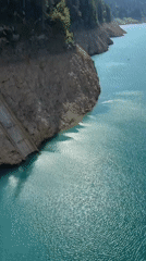 Alpine lake and dam in Italy's Dolomites on a clear summer day