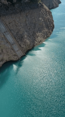 Alpine lake and dam in Italy's Dolomites on a clear summer day