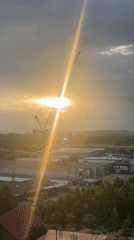 Sunset captured behind construction cranes in Pattaya City