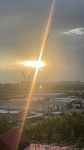 Sunset captured behind construction cranes in Pattaya City