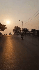 Morning motorcycle traffic and street life in Banjarmasin