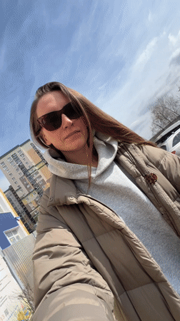 Woman takes selfie with baby in stroller in Vitenyovo