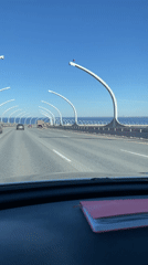 Vehicle crosses bridge in St. Petersburg under clear skies
