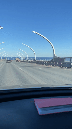 Vehicle crosses bridge in St. Petersburg under clear skies