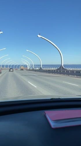 Vehicle crosses bridge in St. Petersburg under clear skies