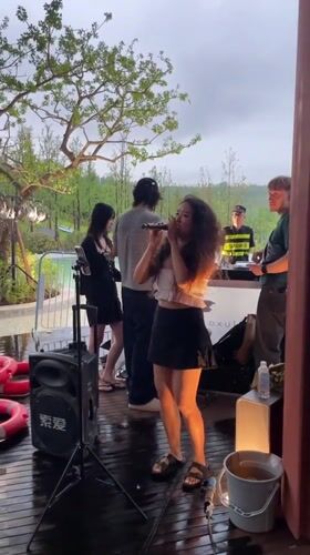Live performance at a lakeside outdoor venue in Liangjiang