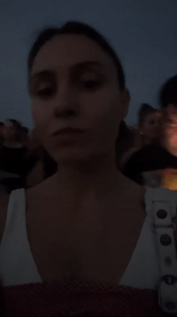 Evening crowd gathers on Barcelona's industrial waterfront at dusk