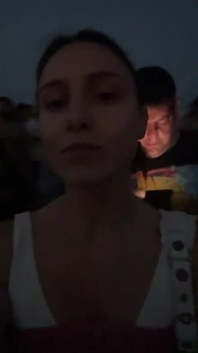 Evening crowd gathers on Barcelona's industrial waterfront at dusk