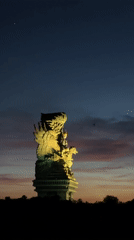 Families gather at Bali statue park during sunset activities