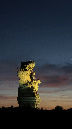 Families gather at Bali statue park during sunset activities