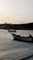 Sunset observed over Juan Griego harbor with fishing boats