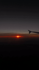 Aircraft passenger witnesses sunset view over Riedering, Germany