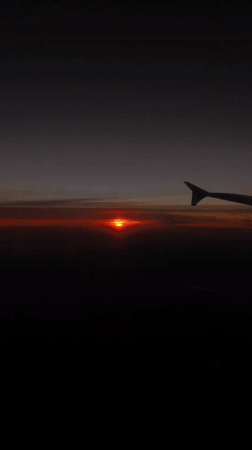 Aircraft passenger witnesses sunset view over Riedering, Germany