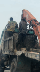 Workers maintain crane truck in Haifam, Nigeria