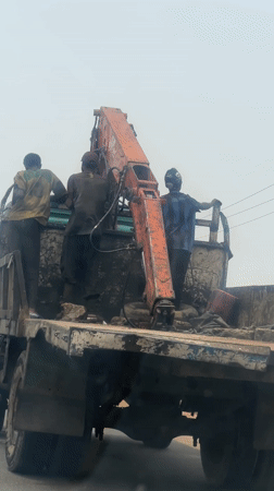 Workers maintain crane truck in Haifam, Nigeria