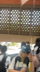 Young travelers use escalator at Kuta transportation hub