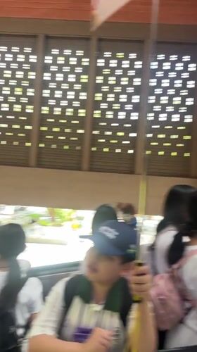 Young travelers use escalator at Kuta transportation hub