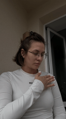 Woman in white top with glasses observed early morning