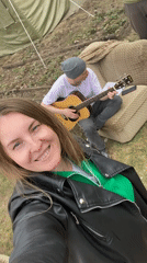 Camping gathering with guitar music and food sharing in Chaikovsky