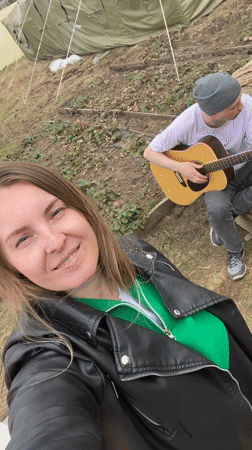 Camping gathering with guitar music and food sharing in Chaikovsky