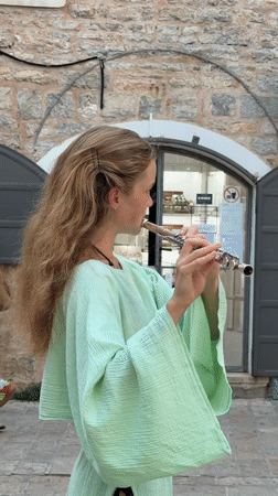 Flute performance and Ferris wheel action on Budva's summer waterfront