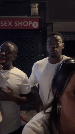 Three people gather outside closed London adult shop