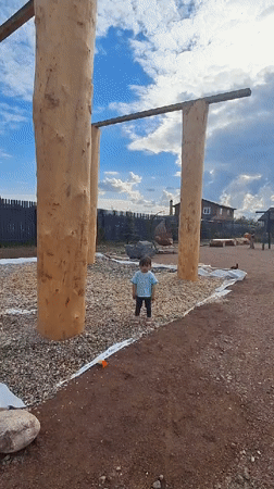 Child plays with cat in Russian villages amid rain-soaked nature