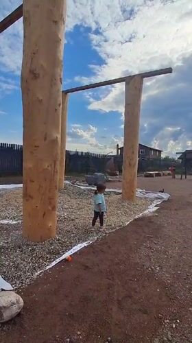 Child plays with cat in Russian villages amid rain-soaked nature