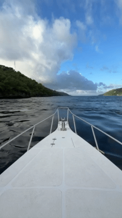 White motorboat navigates choppy waters near Nusa Penida, Indonesia