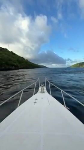 White motorboat navigates choppy waters near Nusa Penida, Indonesia