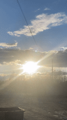 Bright sun creates lens flare in Russian outdoor scene