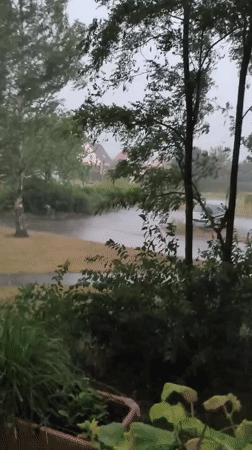 Heavy rainstorm batters a residential area with flooding and wind