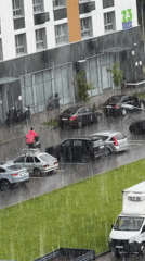 Heavy rain hits a modern residential neighborhood, OZON deliveries continue
