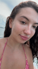 Woman takes selfies on boat near Pemenang, Indonesia