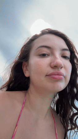 Woman takes selfies on boat near Pemenang, Indonesia