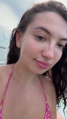 Woman takes selfies on boat near Pemenang, Indonesia