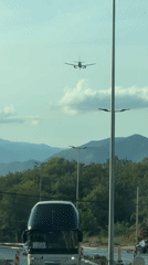 Plane flies over a winding mountain road in Montenegro