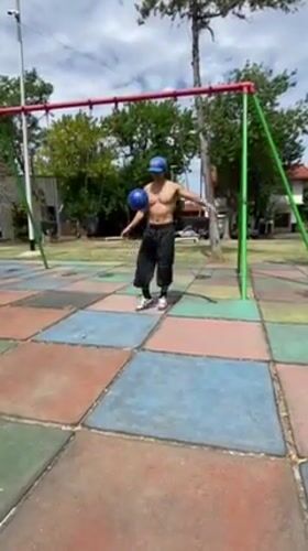 Couple exercises at Argentine playground with pet cat