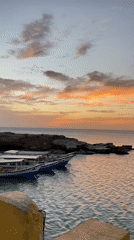 Sunset captured over Juan Griego coast with boats, palms