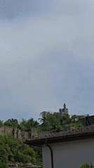 Historic hillside town with wooden bridge and church documented