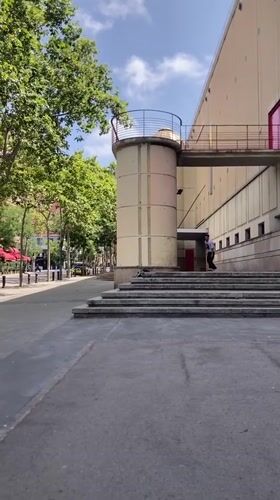 Skateboarder works a Barcelona stairset, mostly bailing