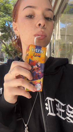 Woman drinks juice box on Buenos Aires street