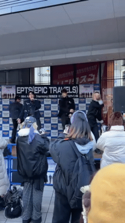 K-pop style group performs on outdoor stage in Osaka