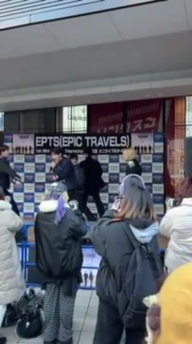 K-pop style group performs on outdoor stage in Osaka