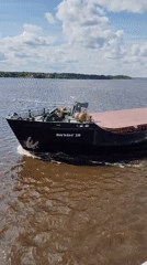 Cargo barge navigates Volga River near Goritsy monastery