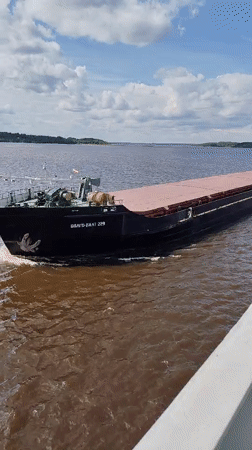 Cargo barge navigates Volga River near Goritsy monastery