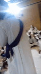 Indoor gathering in white robes and prayer beads