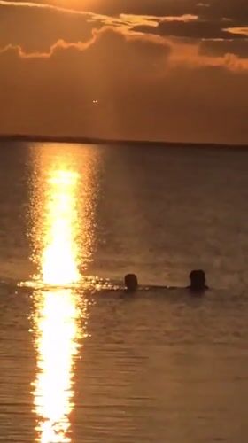 Golden hour beach gathering in Kokshetau during sunset